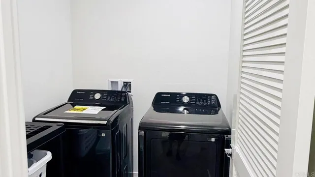 a view of walk in closet with clothes