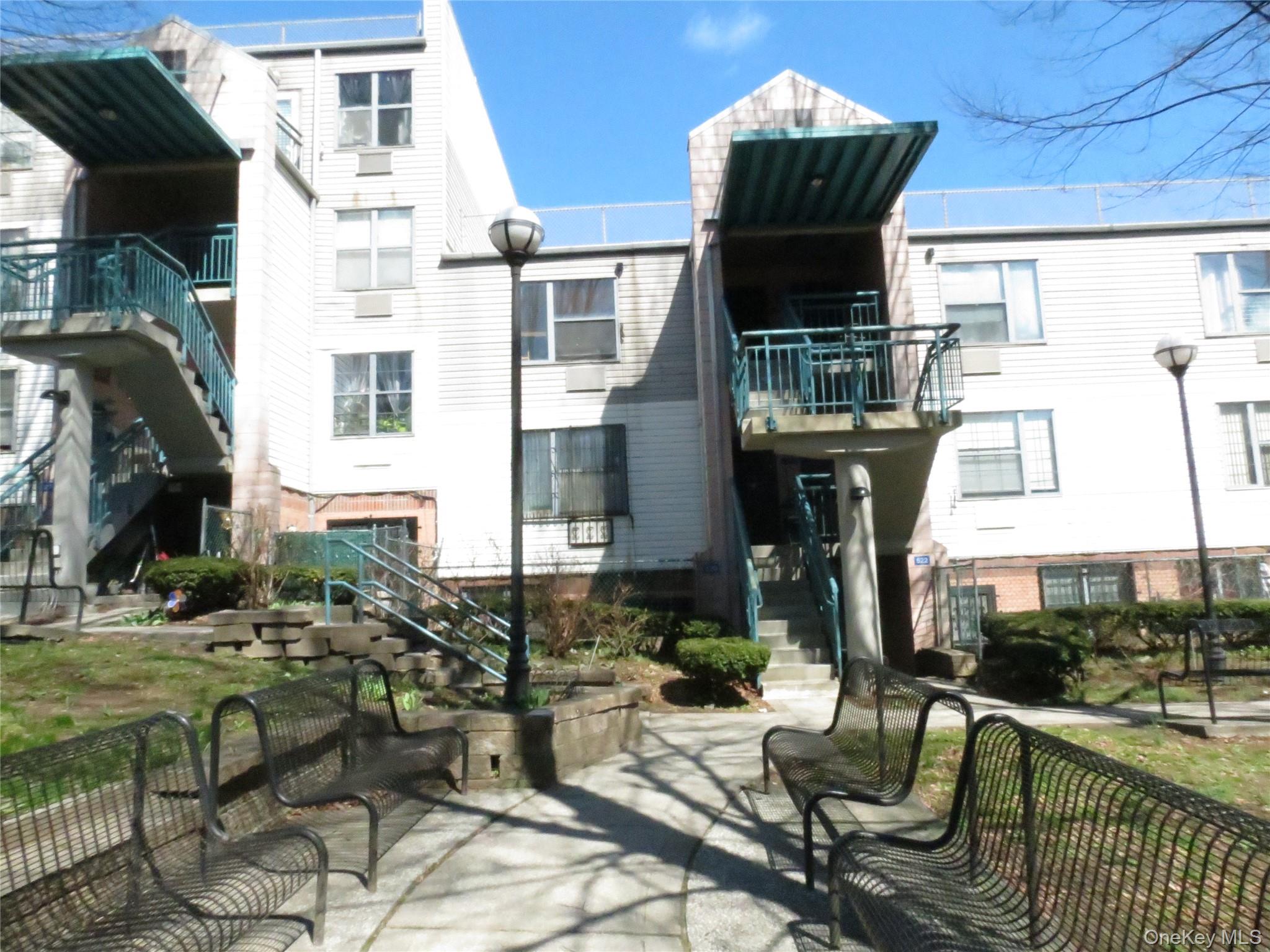 a front view of a building with outdoor seating