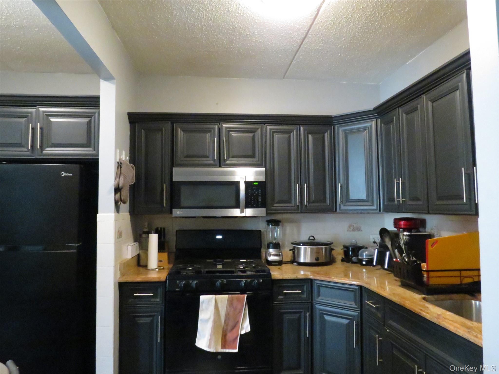522 East 159th Street, Unit 2B Bronx, NY 10451 - Photo 2 of 12 a kitchen with stainless steel appliances granite countertop a refrigerator a stove a sink and dishwasher