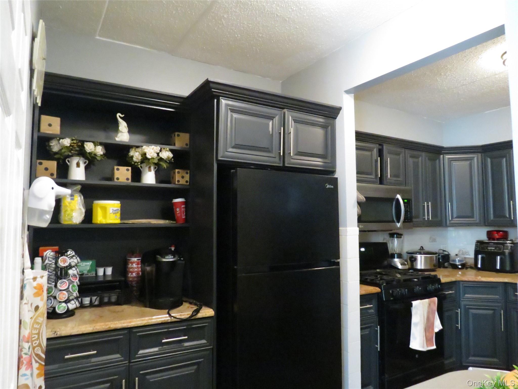 522 East 159th Street, Unit 2B Bronx, NY 10451 - Photo 3 of 12 a kitchen with stainless steel appliances granite countertop a refrigerator and a stove