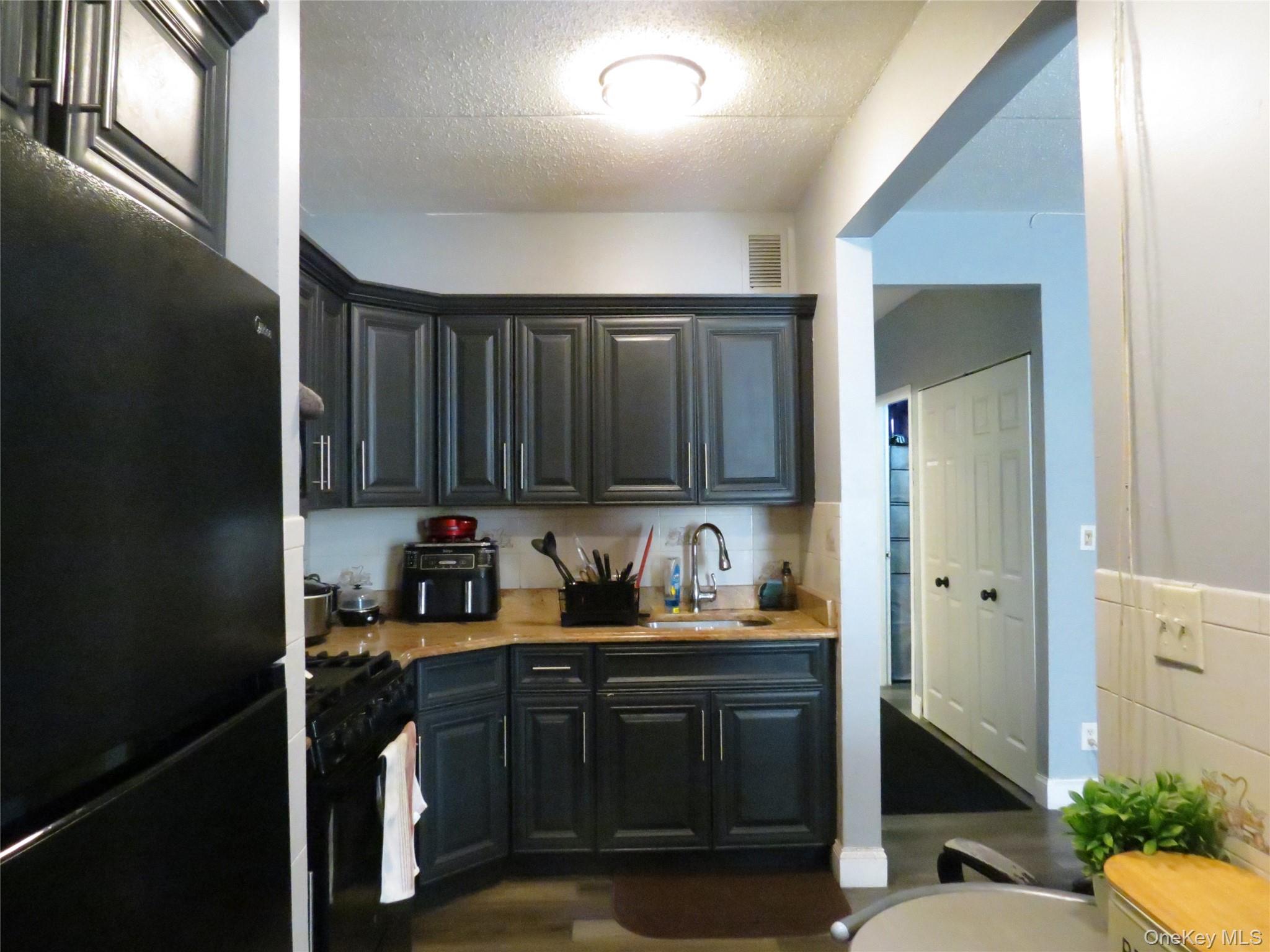 522 East 159th Street, Unit 2B Bronx, NY 10451 - Photo 4 of 12 a kitchen with a sink and cabinets