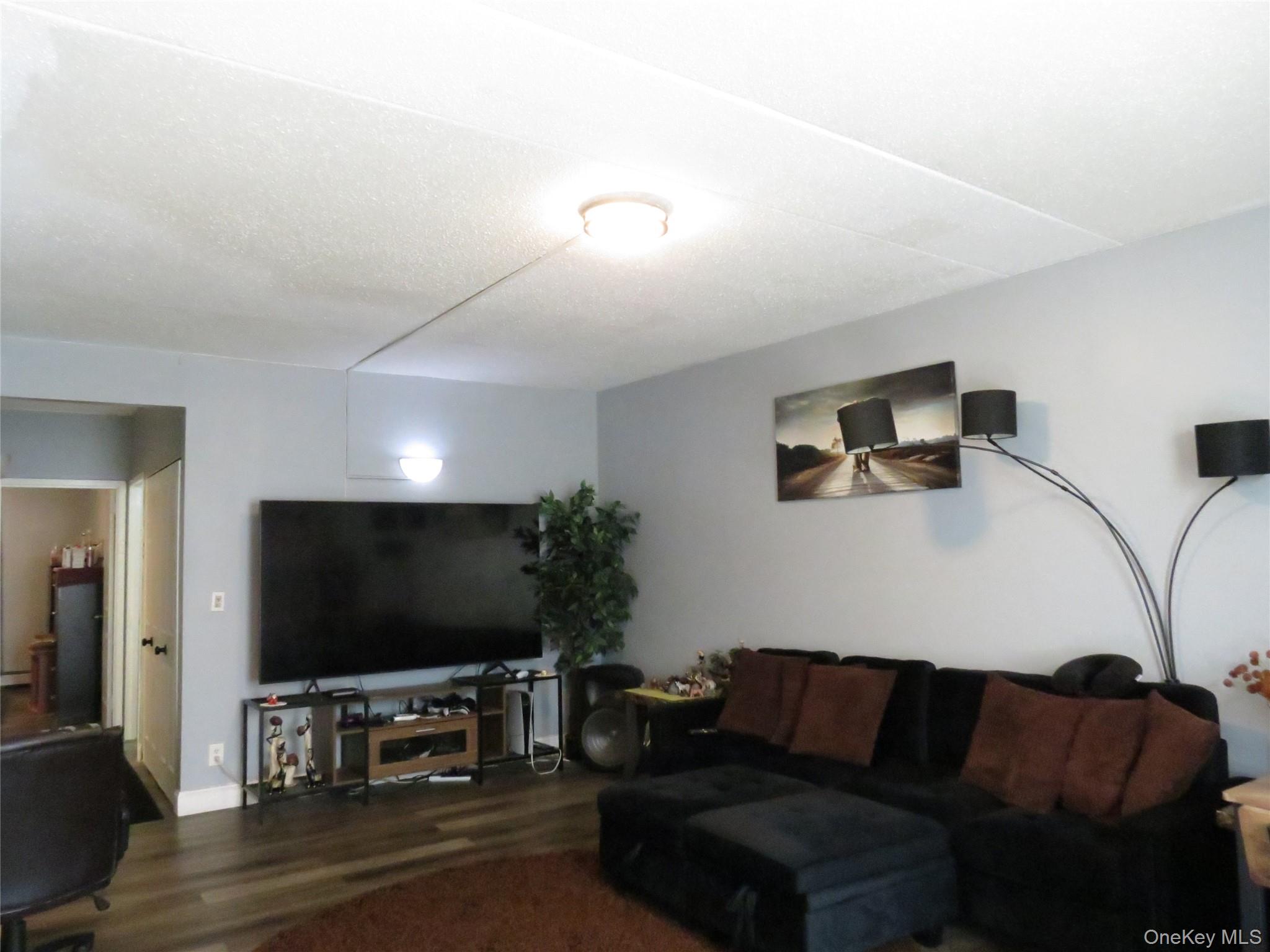 522 East 159th Street, Unit 2B Bronx, NY 10451 - Photo 7 of 12 a living room with furniture and a flat screen tv