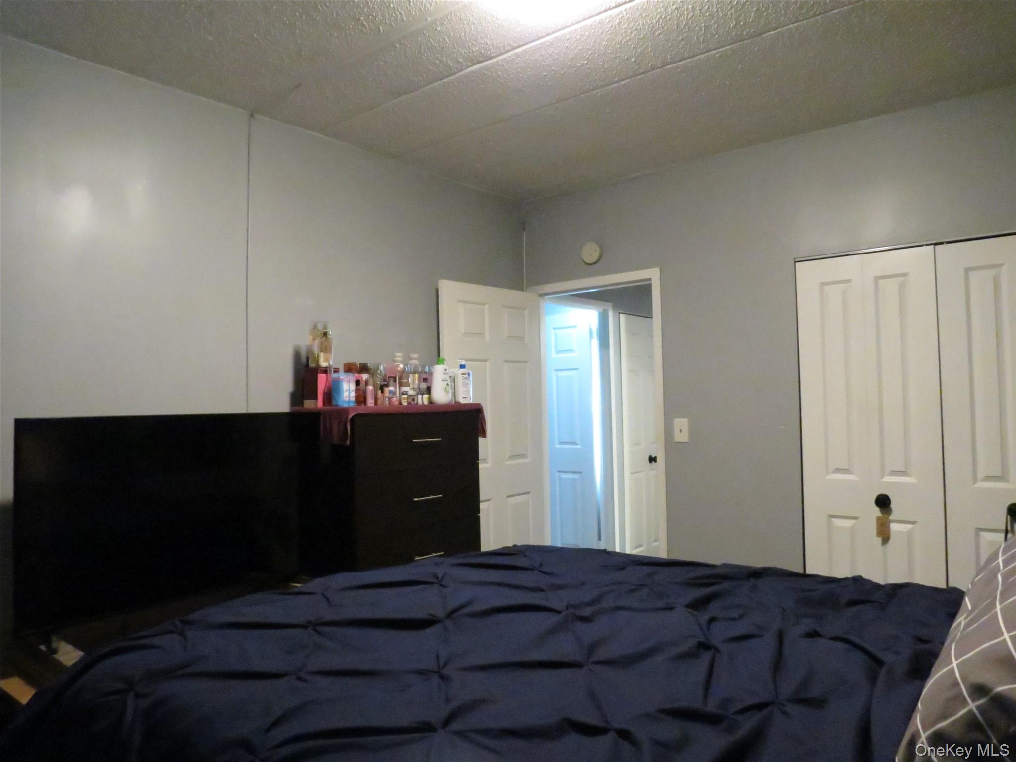 522 East 159th Street, Unit 2B Bronx, NY 10451 - Photo 9 of 12 a bedroom with a bed and a dresser
