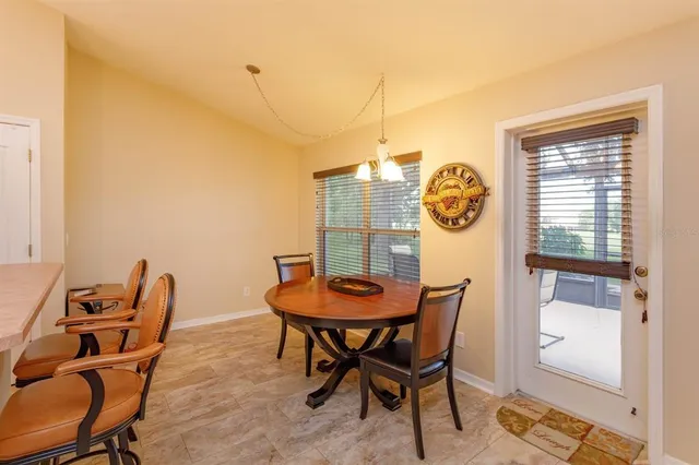 a view of a dining room with furniture and a window