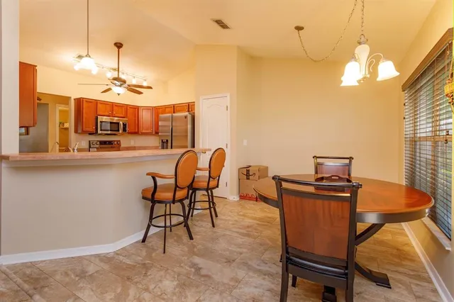 a view of a dining room with furniture and a chandelier