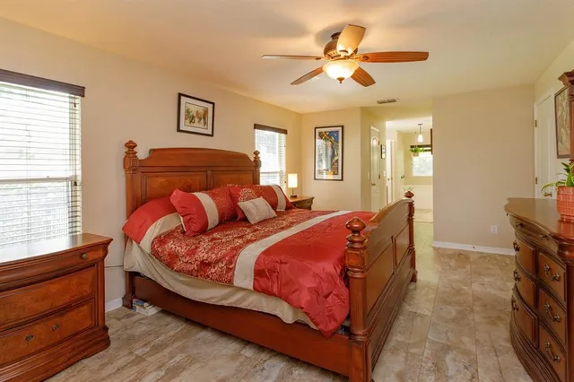 a bedroom with two beds and window