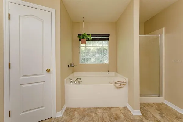 a bathroom with a tub sink and mirror