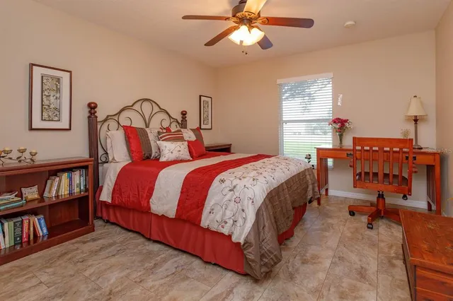 a bedroom with a bed furniture and a book shelf
