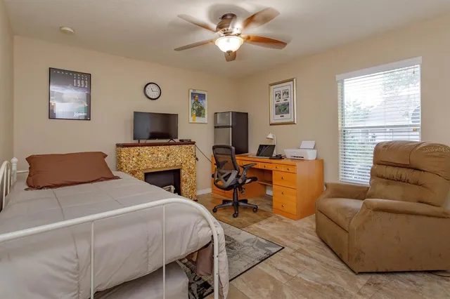 a bedroom with a bed a couch and a window