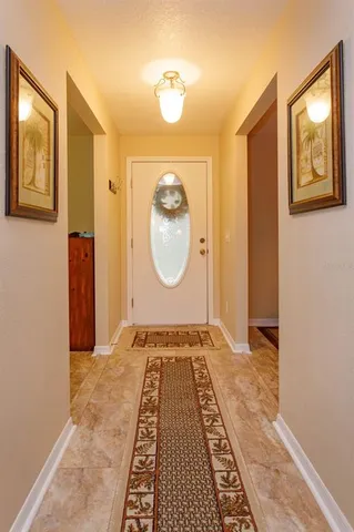 a view of a hallway with wooden floor and door