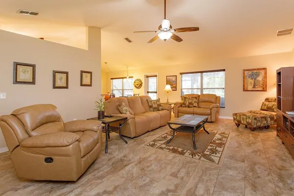 a living room with furniture and a chandelier