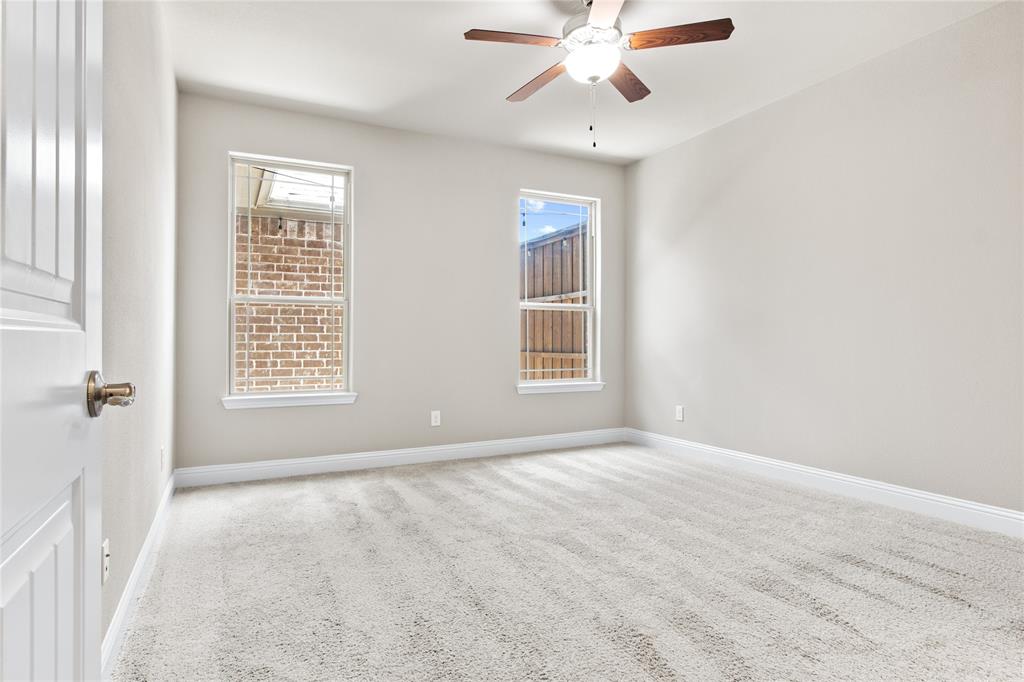 313 Tottenham Court McKinney, TX 75072 - Photo 12 of 31 an empty room with windows and fan