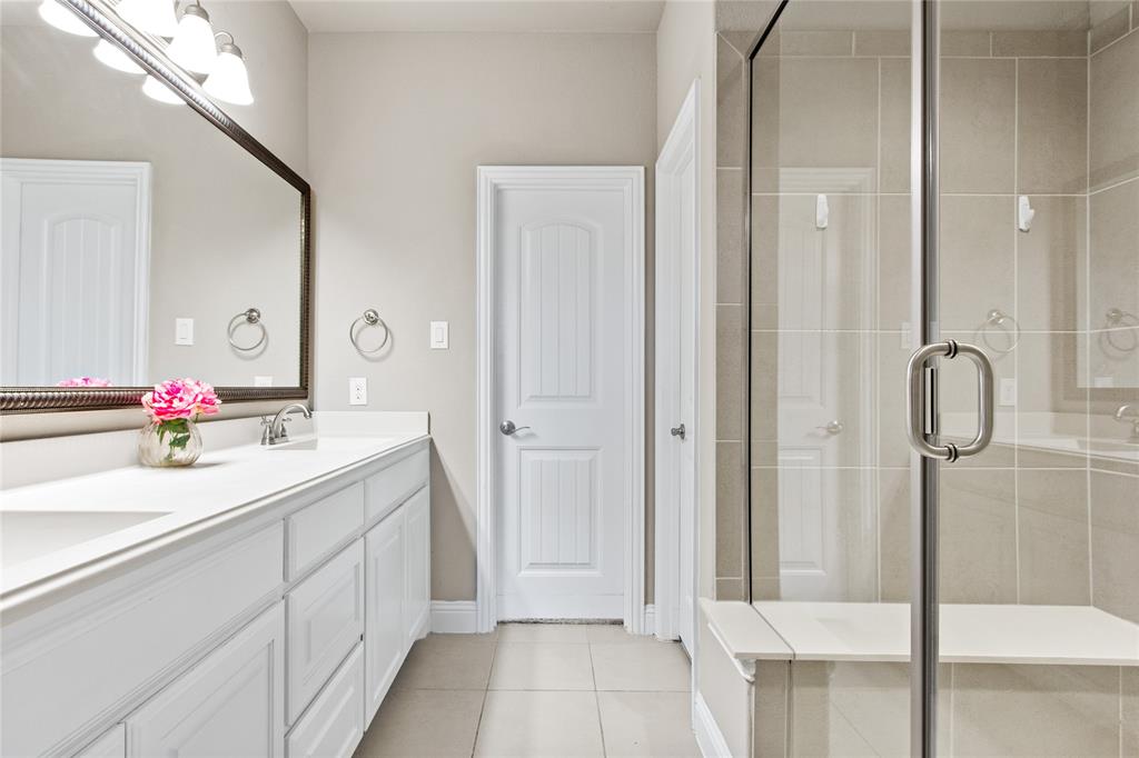 313 Tottenham Court McKinney, TX 75072 - Photo 13 of 31 a bathroom with a double vanity sink and mirror