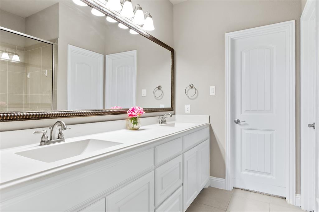 313 Tottenham Court McKinney, TX 75072 - Photo 14 of 31 a bathroom with a double vanity sink and a mirror