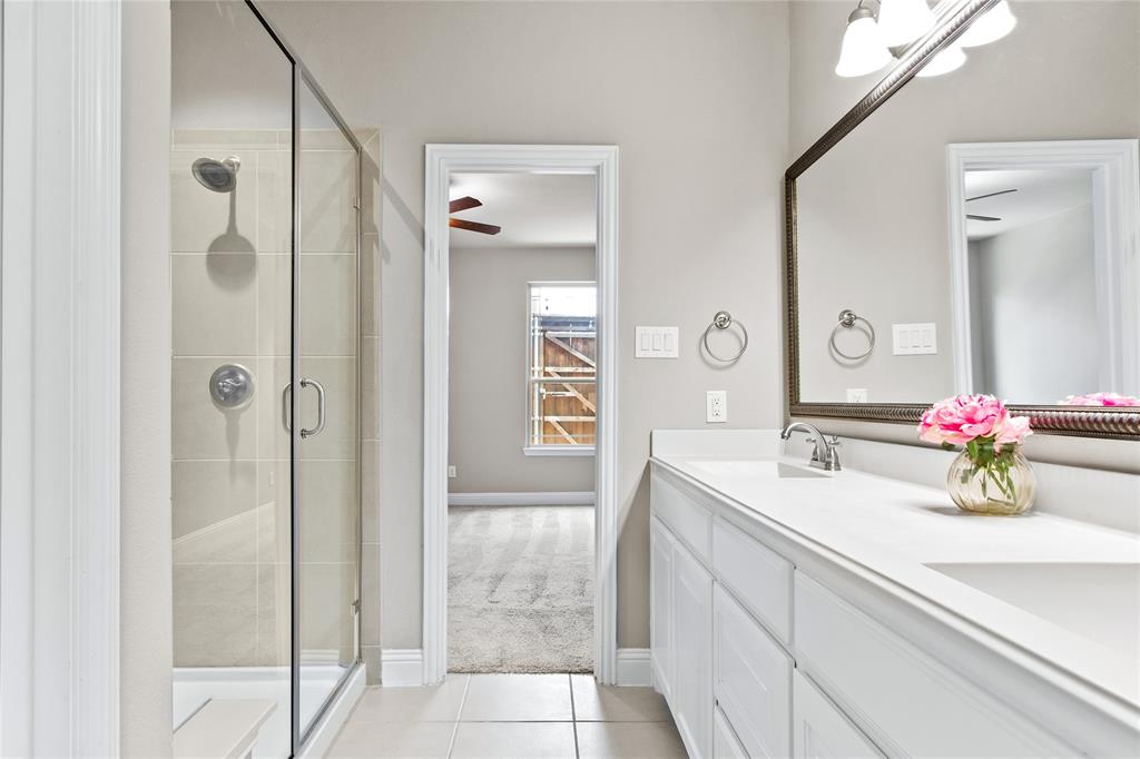 313 Tottenham Court McKinney, TX 75072 - Photo 15 of 31 a bathroom with a double vanity sink mirror and shower