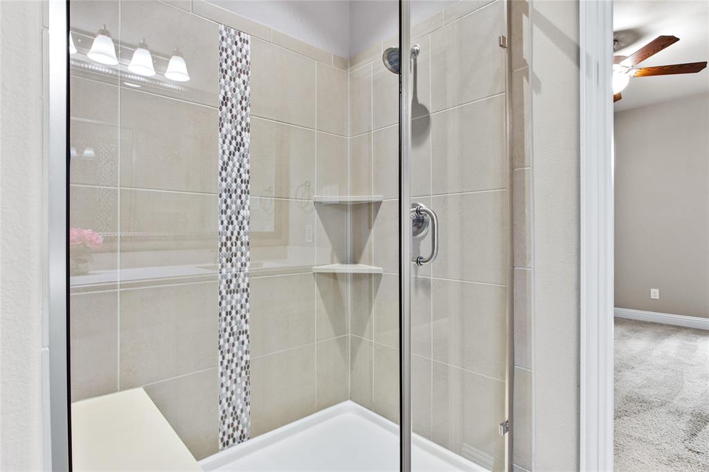 313 Tottenham Court McKinney, TX 75072 - Photo 16 of 31 a bathroom with a shower and a glass door