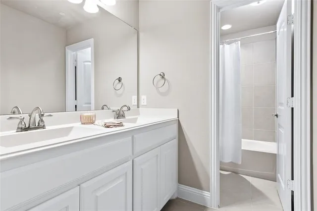 a bathroom with a double vanity sink mirror and double