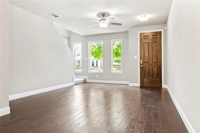 wooden floor in an empty room with a window