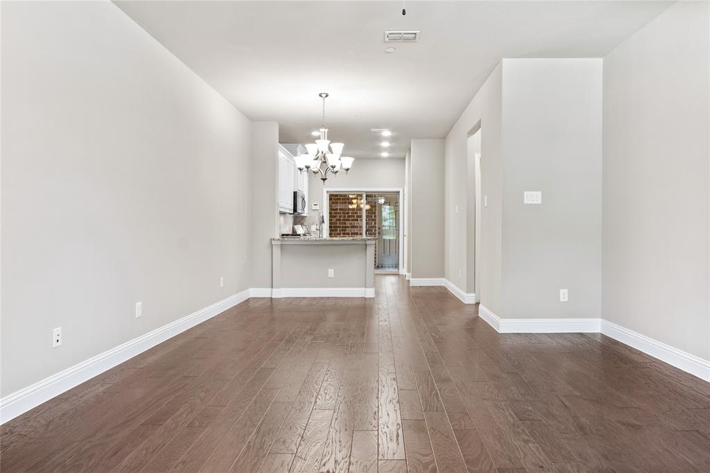 313 Tottenham Court McKinney, TX 75072 - Photo 5 of 31 wooden floor in an empty room with a window