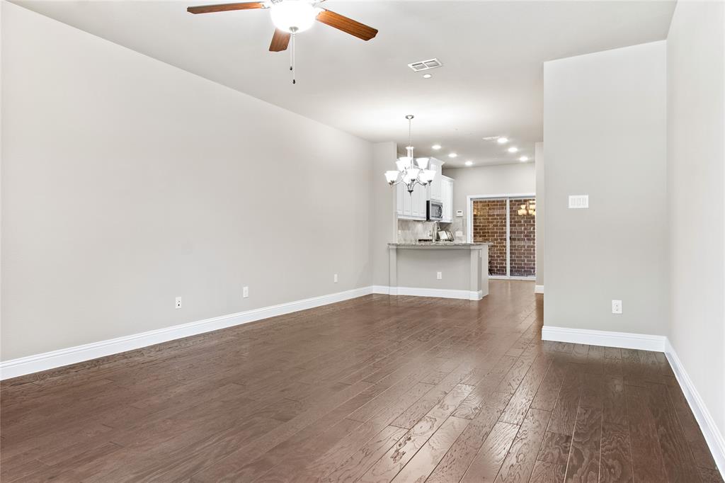 313 Tottenham Court McKinney, TX 75072 - Photo 6 of 31 wooden floor in an empty room with a window