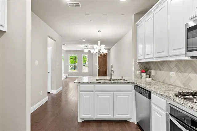 a kitchen with a sink stove and cabinets