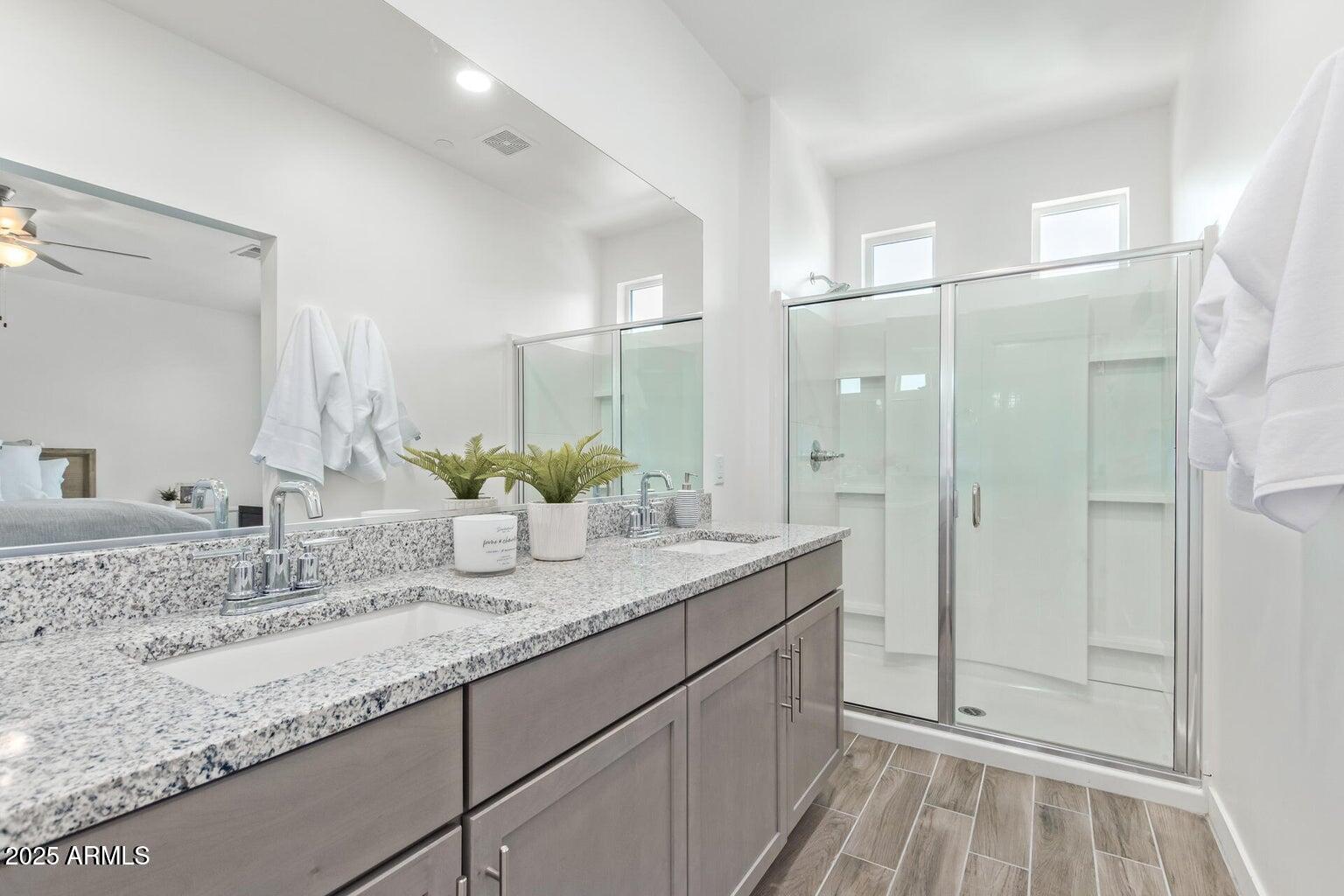 3230 East Thomas Road, Unit 168 Mesa, AZ 85213 - Photo 17 of 26 a bathroom with a granite countertop sink and a mirror