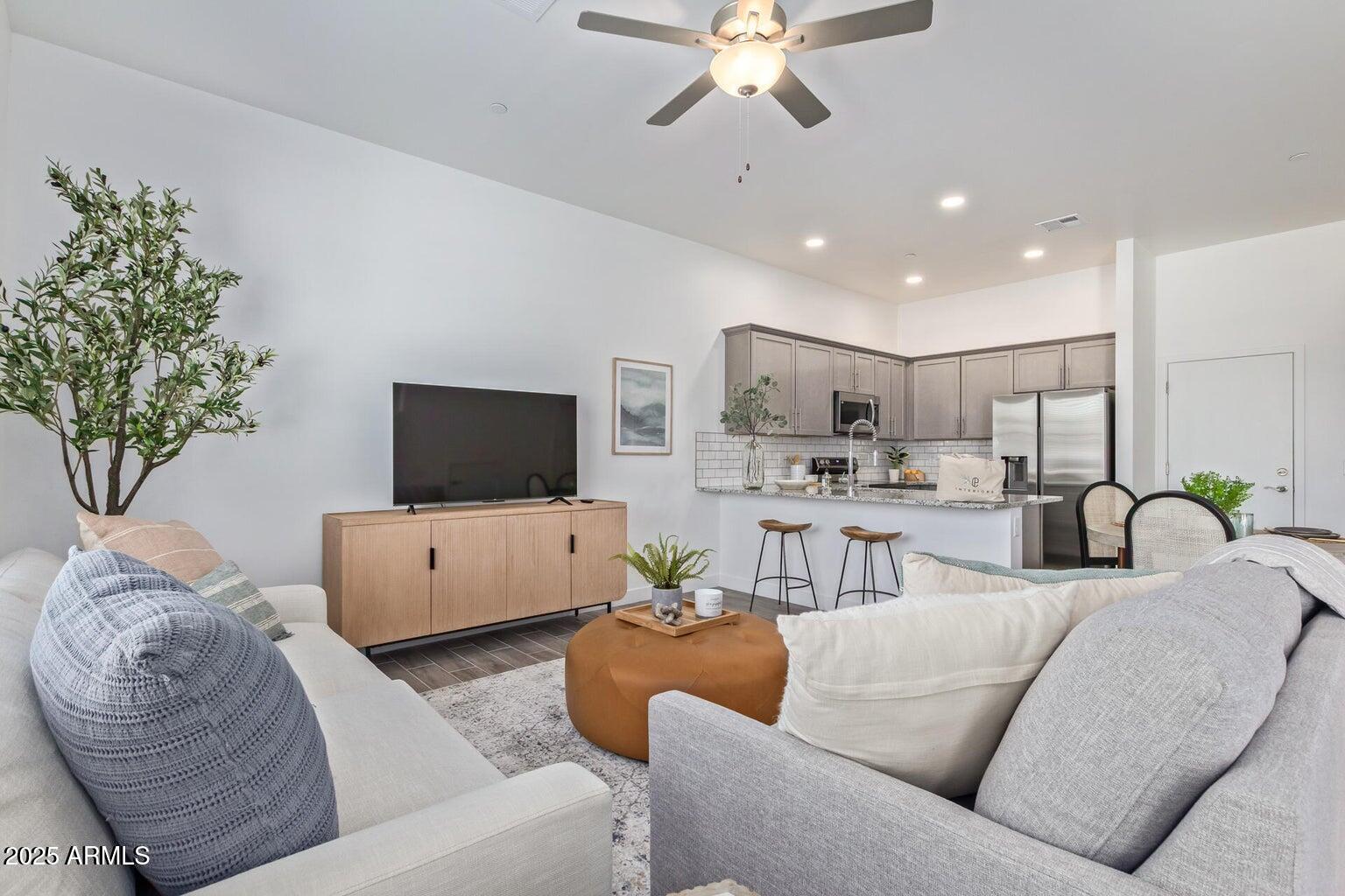 3230 East Thomas Road, Unit 168 Mesa, AZ 85213 - Photo 2 of 26 a living room with furniture kitchen and a chandelier