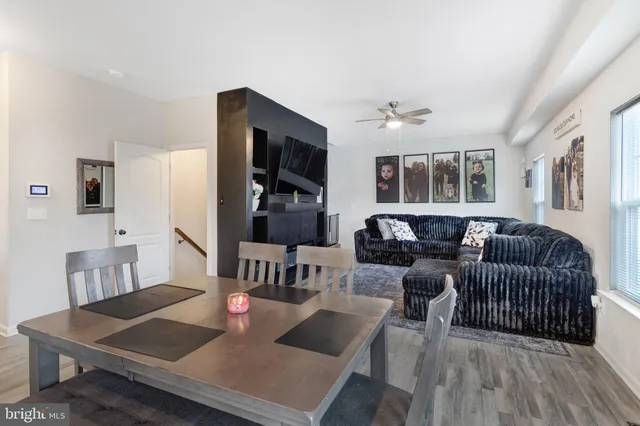 a living room with furniture rug and wooden floor