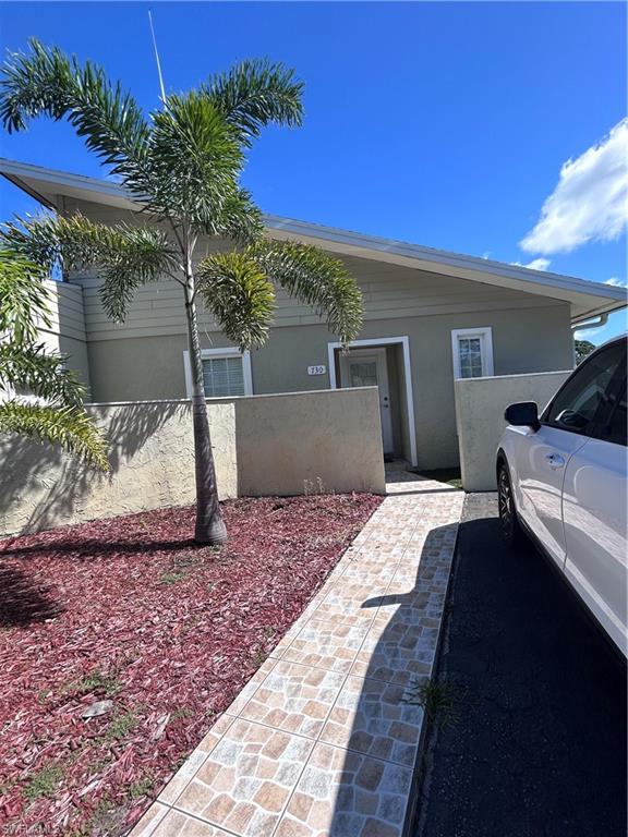 730 111th Avenue North Naples, FL 34108 - Photo 10 of 12 a front view of a house with a yard