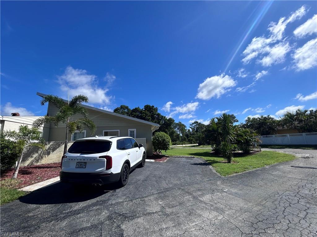 730 111th Avenue North Naples, FL 34108 - Photo 11 of 12 a front view of a house with a yard