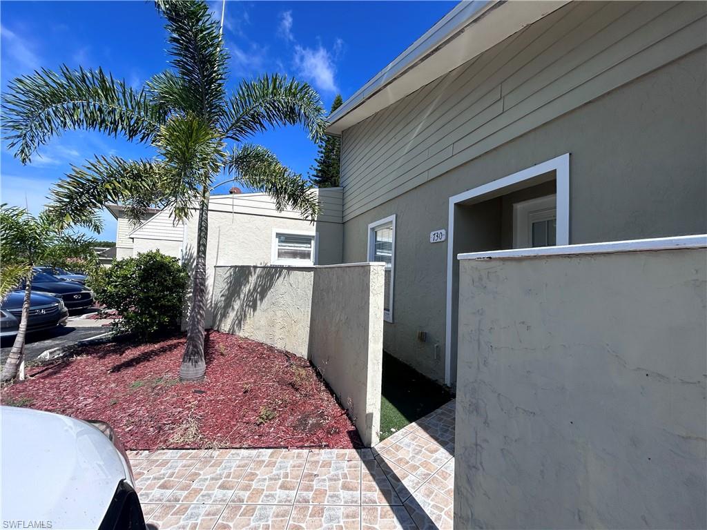 730 111th Avenue North Naples, FL 34108 - Photo 2 of 12 a view of a backyard with a large tree