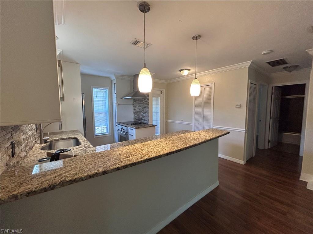 730 111th Avenue North Naples, FL 34108 - Photo 3 of 12 a large bathroom with granite countertop a sink and vanity