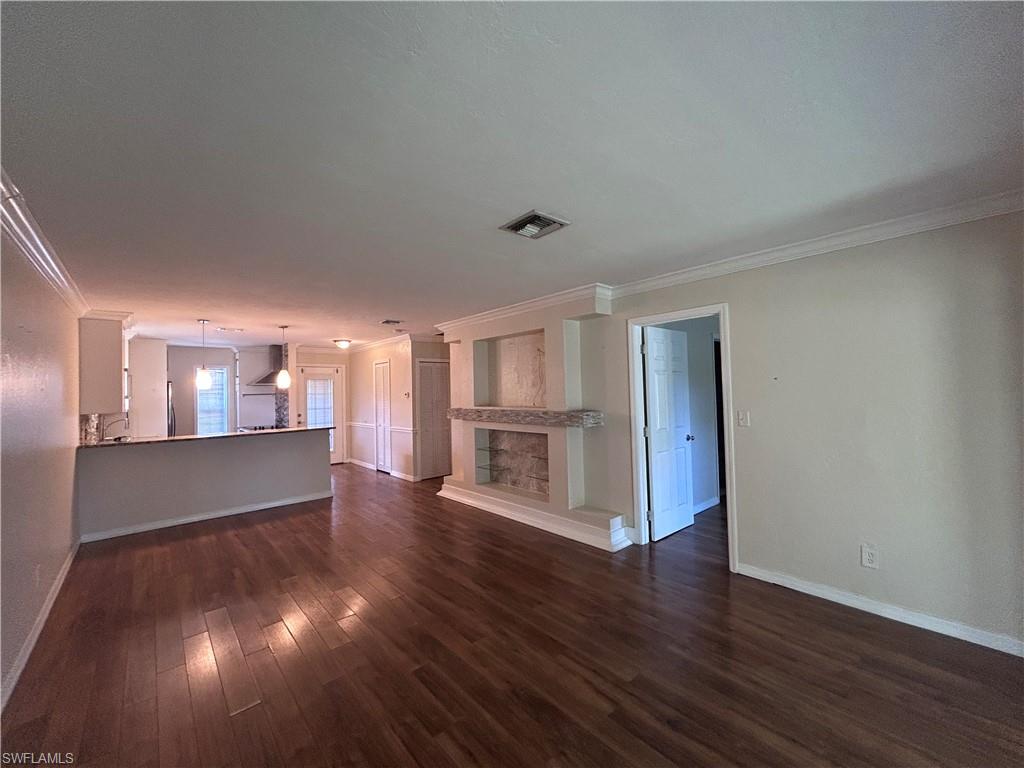 730 111th Avenue North Naples, FL 34108 - Photo 4 of 12 a view of empty room with wooden floor