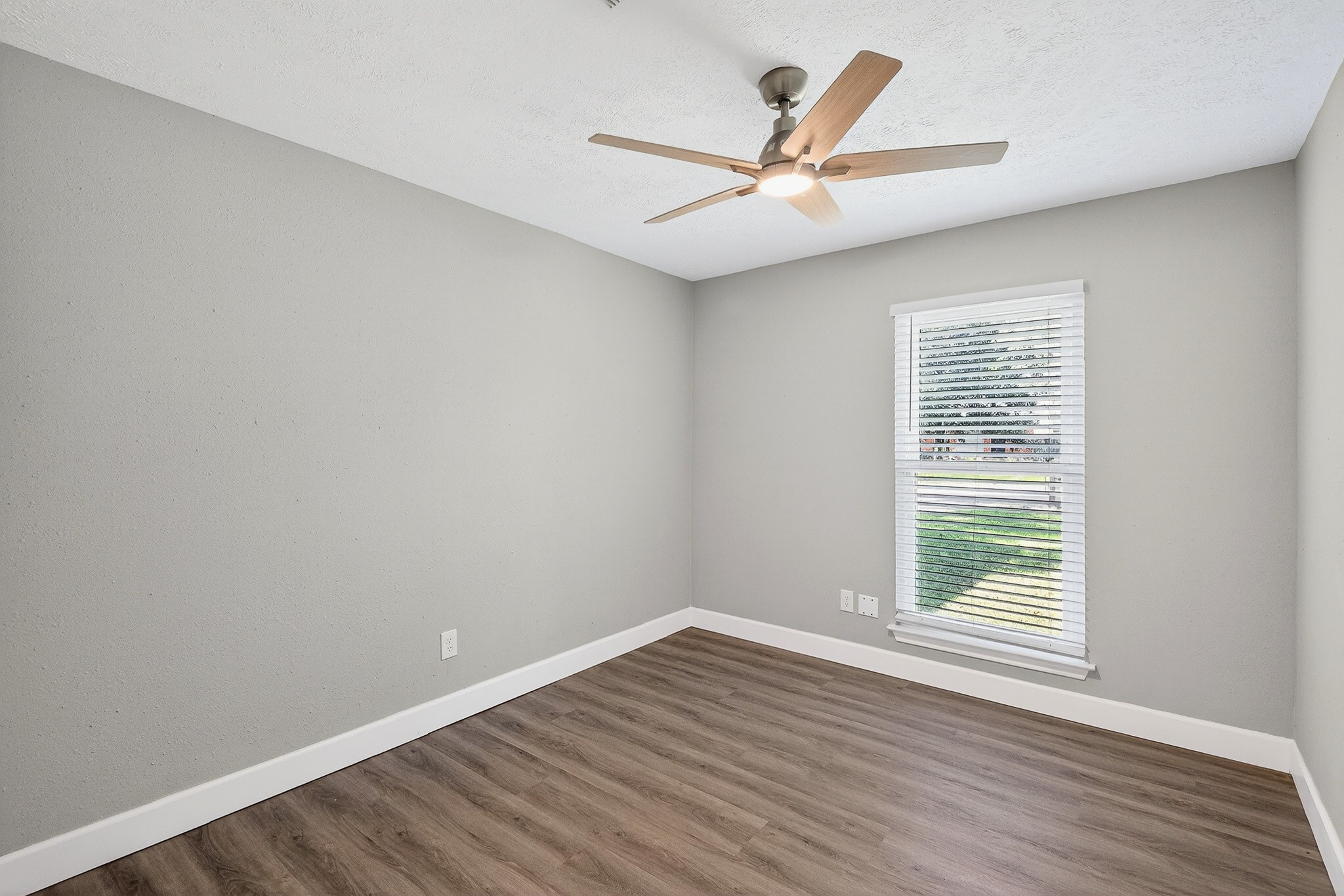 2510 Marble Falls Drive Spring, TX 77373 - Photo 16 of 26 an empty room with wooden floor fan and windows