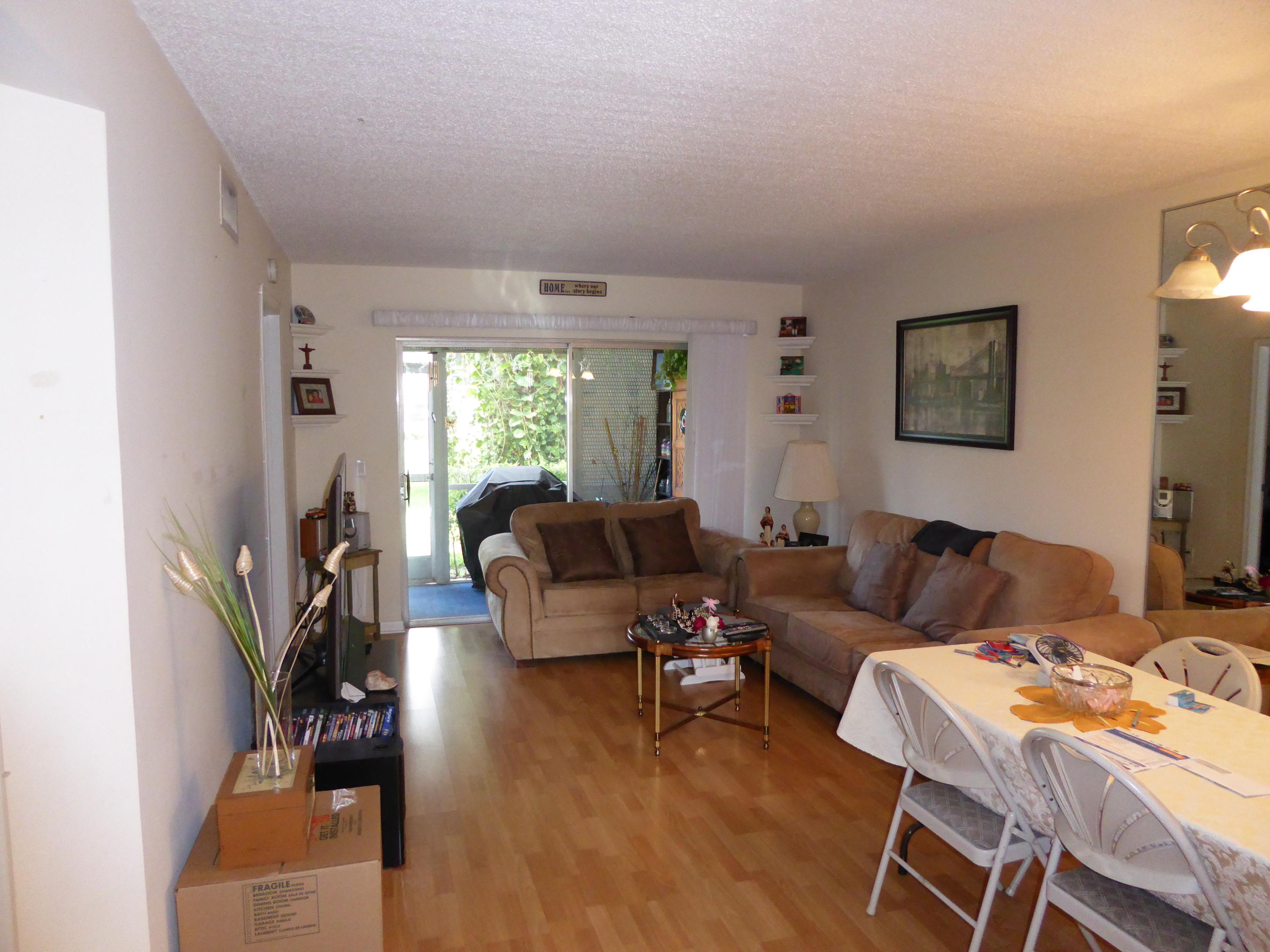 9911 Sandalfoot Boulevard, Unit 105 Boca Raton, FL 33428 - Photo 6 of 14 Living/Dining Area