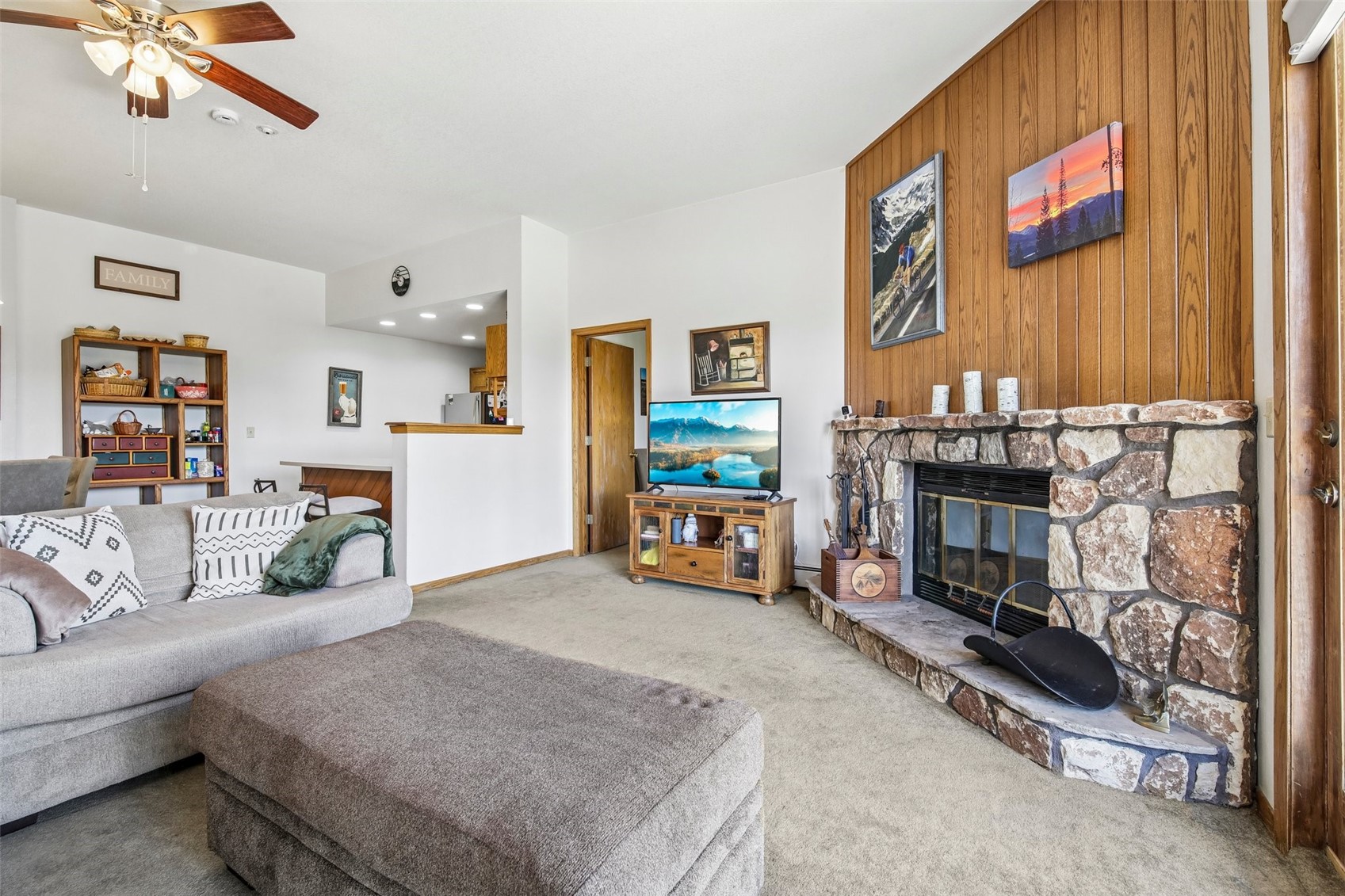 89310 Ryan Gulch Road, Unit 103 Silverthorne, CO 80498 - Photo 3 of 48 a living room with furniture and a fireplace