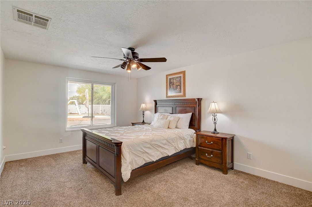 4362 Thistle Street Logandale, NV 89021 - Photo 58 of 99 Well-lit sleeping quarters offering a restful escape and comfortable carpeting.