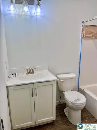 a bathroom with a sink a toilet and a mirror