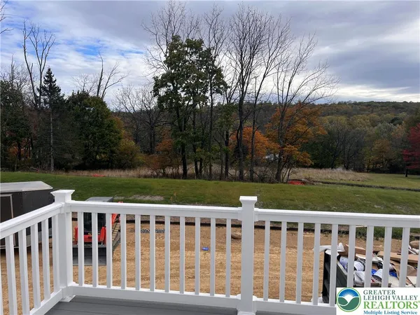a view of a wooden deck with a yard