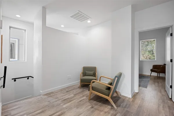 a work room with furniture and wooden floor