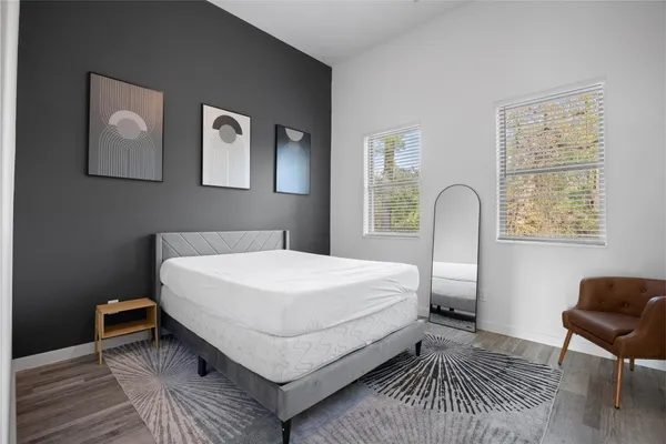 a bed room with a bed and a chair