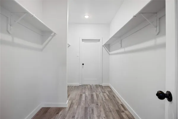a view of a room with wooden floor