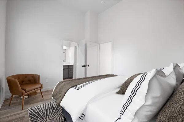 a bedroom with a bed and chair