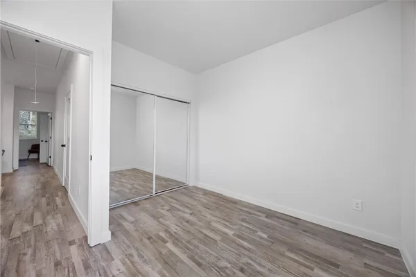 a view of a room with wooden floor