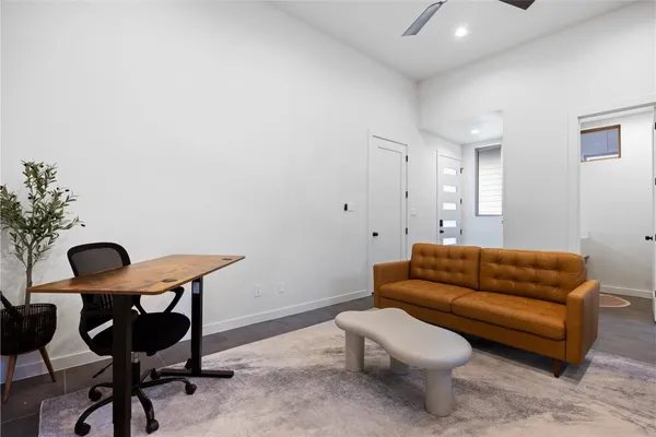 a living room with furniture and a chair