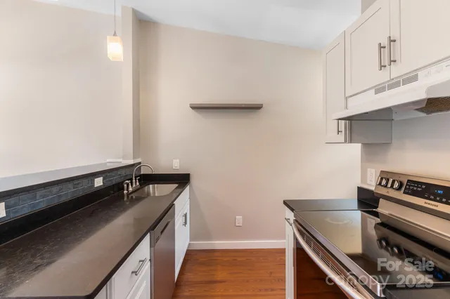 a kitchen with a stove and a cabinets