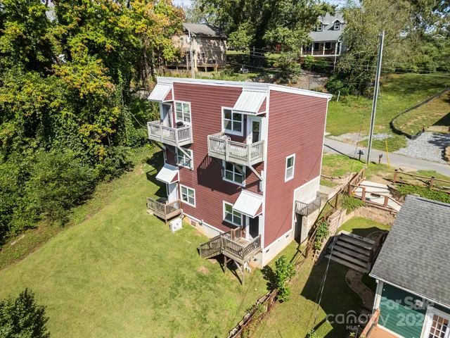 an aerial view of a house with a yard basket ball court and outdoor seating