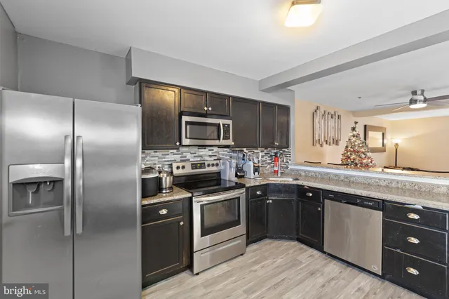 a kitchen with a sink stainless steel appliances and cabinets