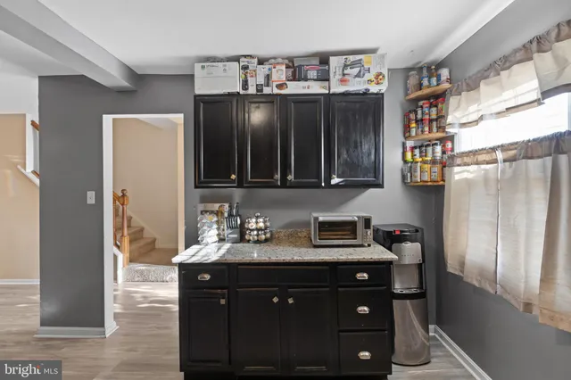 a bathroom with a sink vanity and a mirror