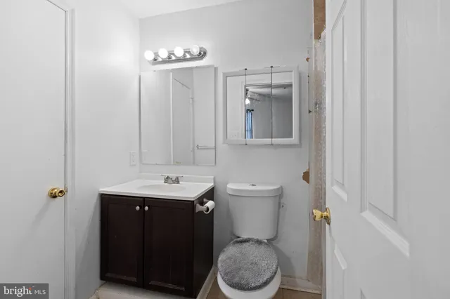 a bathroom with a sink a toilet and a mirror